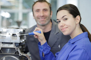 woman and man as mechanics in workshop