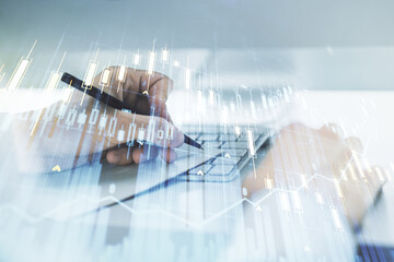 Multi exposure of abstract financial graph with hand writing in notebook on background, financial and trading concept © Pixels Hunter