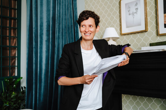 Smiling director holding script at film set