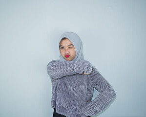 Excited happy Asian Muslim woman celebrating victory and happiness isolated over white background