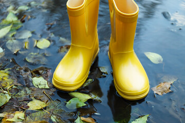 Yellow rubber boots outdoor in rainy weather