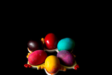 Colored easter eggs on a black background