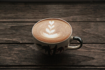 Hot Latte art coffee with Heart shape on wooden table at coffee cafe - Food and Drink Scene - Image From Nan Thailand 