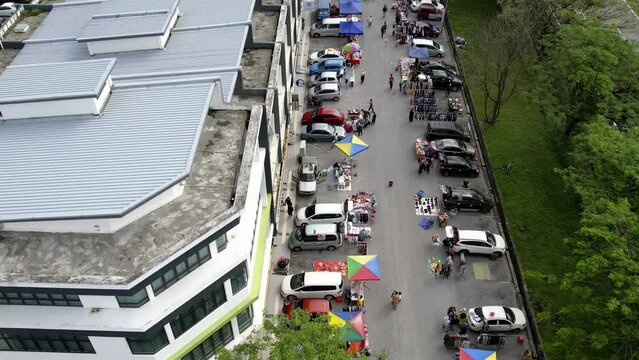  Selangor, Malaysia - March 5, 2023, Trailing aerial view of car boot morning market in Bandar Seri Putra.
