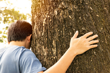 A man huging trunk of tree. Mother Earth day. World environment day, Eco friendly and...