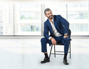 Businessman sitting in office holding contract and talking on the phone, Businessman sitting on a chair in a new apartment, Housing Loan concept