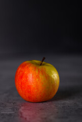 Close view Red and green apple isolated on a dark background