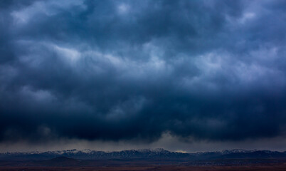 Rain clouds over a mountain range in the distance. Change of weather in the rainy season....