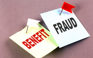 BENEFIT FRAUD text on a sticky on grey background