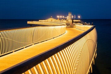 The new modern pier in Koserow, Usedom, northern Germany, opened in 2021, lit during the blue hour after sunset