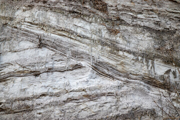 Layered texture of a high shore being eroded by the sea, creating a stunning pattern.