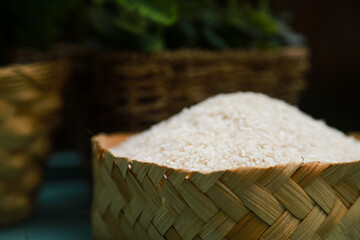white rice seeds on a bamboo bowl