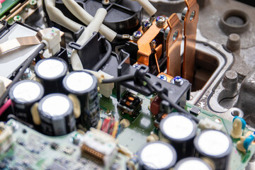 On-board charger unit disassembled for repair. Connecting siovye tires are visible. The group of...