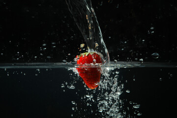 Tasty strawberry in water, concept of freshness