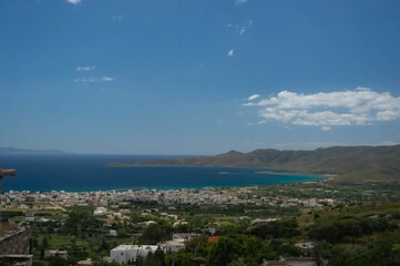 Fototapeta na wymiar View of the sea bay and the village. Euboea island, Greece. Turquoise water and blue sky.