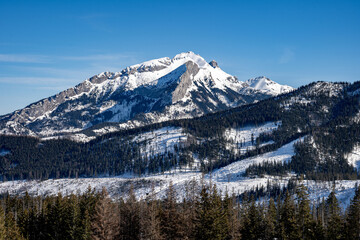 View of the Tatra Mountains in winter from Rusinowa Polana. Sunny weather during a hike in the mountains. © Tomasz