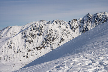 View of the Tatra Mountains in winter from the peak of Kasprowy Wierch. Sunny weather during a hike in the mountains.