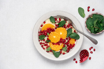 Couscous salad with oranges, pomegranate seeds and mint. Seasonal fruit salad. Middle eastern food