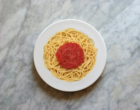 Plate Of Spaghetti With Tomato Sauce, Viewed From Above On A Marble Tablesemi 
