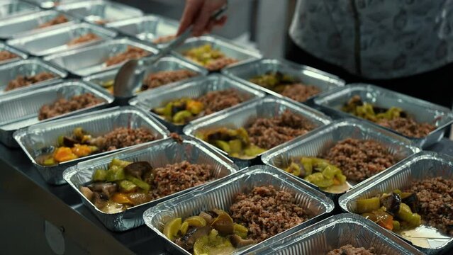 volunteer fill lunch boxes with food free food for poor people Humanitarian Aid