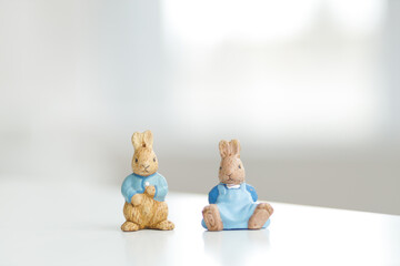 Handmade Easter bunny. Blurred background. Easter toys. Wooden Easter eggs on white background, copy space.
