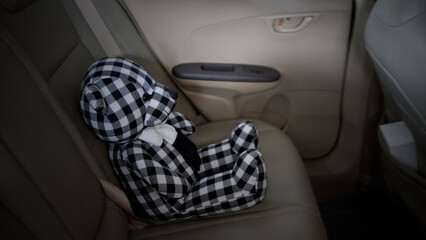 lonely teddy bear sitting alone in the car for created postcard  of international missing children,...