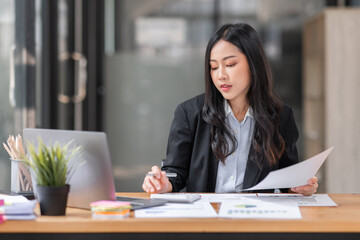 Young business Asian woman using a calculator to Tax deduction planning concept. Businessman calculating business balance prepare loan documents, tax reduction invoices.