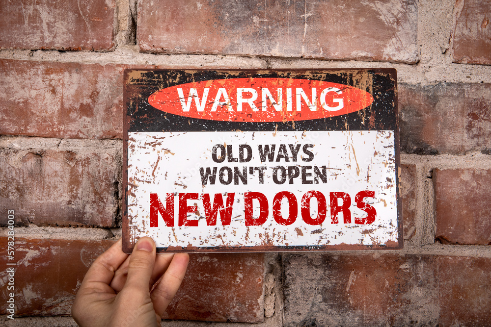 Wall mural old ways won't open new doors. warning sign with text