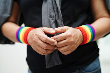Asian woman with rainbow flag, LGBT symbol rights and gender equality, LGBT Pride Month in June.