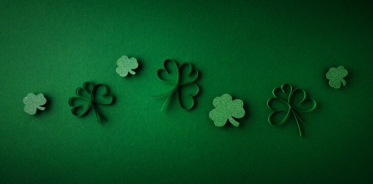 Saint Patrick day flat lay concept with shamrock clover on green background