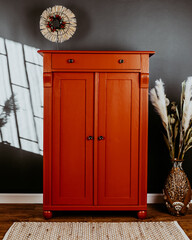 Vertiko after renovation painted in red