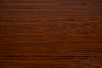 Reddish brown wood grain background.