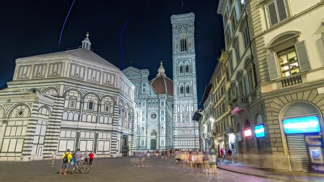 The front of The Basilica di Santa Maria del Fiore and Baptistery San Giovanni night timelapse hyperlapse. Cathedral church (Duomo) of Florence in Italy. Evening illumination. Bell tower and dome