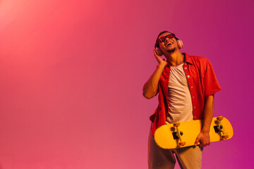 African man posing with skateboard isolated over gradient neon background