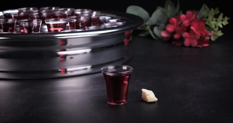 Taking communion concept - the wine and the bread symbols of Jesus Christ blood and body with Holy Bible. Easter Passover and Lord Supper concept. Dolly shot 4k