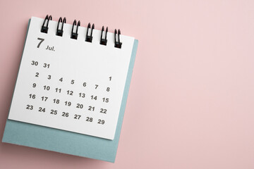 close up of calendar on the pink table background, planning for business meeting or travel planning concept