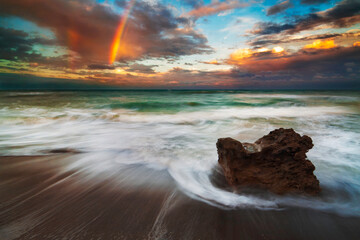 sunset on the beach with rainbow