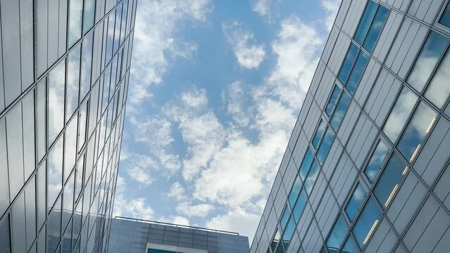 Business building and clouds concept. Blue sky and achitecture, modern city office and skyscraper, center.