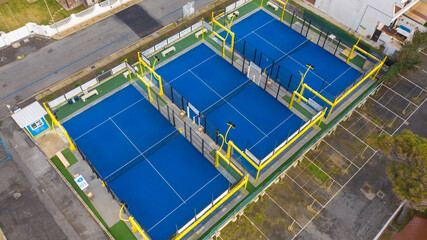 Aerial view on three padel courts in a sport center in Italy.