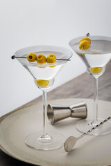 Vodka martini cocktail garnished with olives. Martini alcoholic cocktail or non-alcoholic mocktail. Martinis.