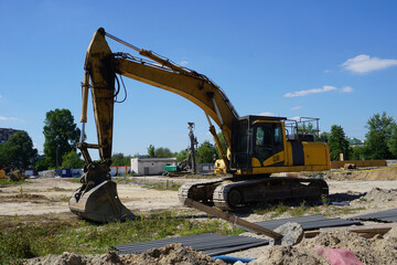 Yellow excavator on construction site
