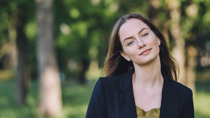 Portrait of a young student in a city park.