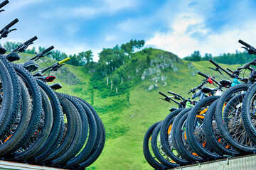 Against the backdrop of a high mountain, mountain sports bikes are transported. The photo shows...