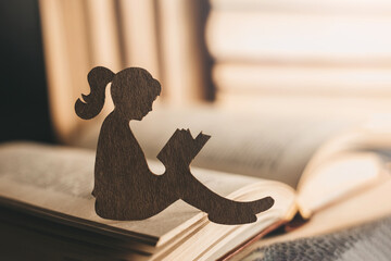 An introvert girl reads a bedtime story against the backdrop of books