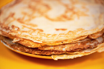 round homemade pancakes no stuffing on a plate on a bright background