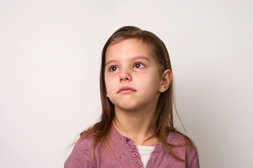 Crying child girl against white background