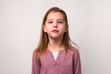Crying child girl against white background
