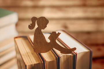 Silhouette of a girl reading a fairy tale