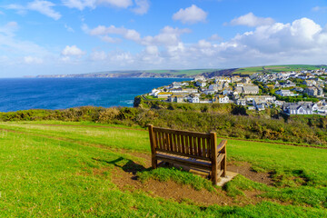 Bench, the village, and the coastline, in Port Isaac