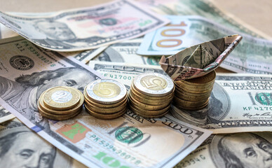 Dollar bills laid out on table. A dollar boat on the highest column of coins, four columns of coins, financial crisis, money, finance, savings, salary, bank, euro cents. Photo, macro photography